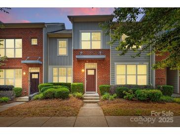 Beautiful brick townhome with manicured landscaping and a serene setting during twilight at 3153 Bending Birch Pl, Charlotte, NC 28206