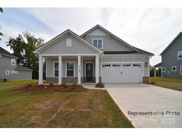 Charming home with a welcoming front porch and attached two-car garage at 4178 Millstream Rd, Denver, NC 28037