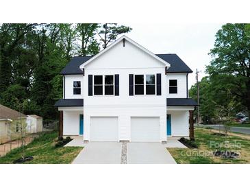 Beautiful new construction duplex featuring a bright white facade and garage at 619 Billingsley Rd, Charlotte, NC 28211