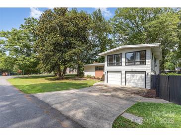 Charming two-story home with a two car garage and lush greenery in the front yard at 747 Saint Michaels Ln # 7, Gastonia, NC 28052
