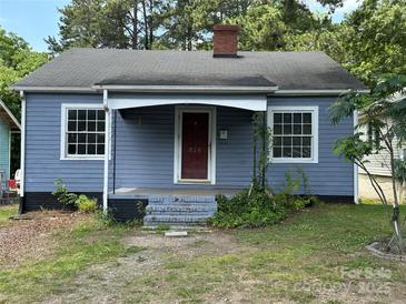 Charming single-story home featuring a covered entry, quaint front yard, and classic architectural details at 839 S Chester St, Gastonia, NC 28052
