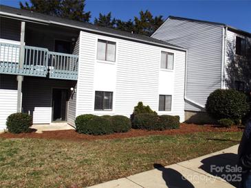 Well-maintained, two-story condo with tidy landscaping and covered balcony at 11010 Harrowfield Rd, Charlotte, NC 28226