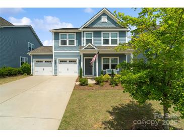 Charming two-story home boasts a two-car garage, manicured lawn, and inviting front porch at 1826 Goodheart Ln, York, SC 29745