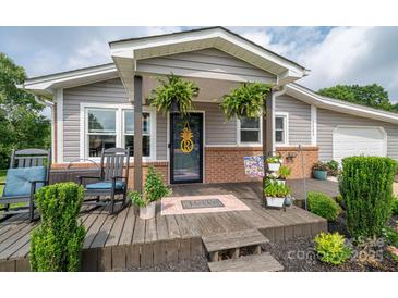 Charming front porch with rocking chair, lovely plants, and welcoming decor on this inviting home at 2206 Whitworth Rd, Cherryville, NC 28021