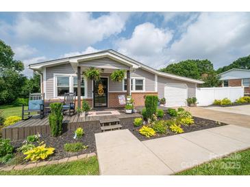 Charming single-story home with a well-manicured front yard and inviting front porch at 2206 Whitworth Rd, Cherryville, NC 28021
