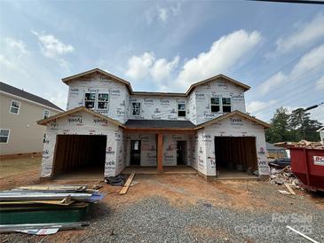 New construction duplex featuring two-car garages, Tyvek house wrap, and a modern design at 2735 Primrose Ave, Charlotte, NC 28208