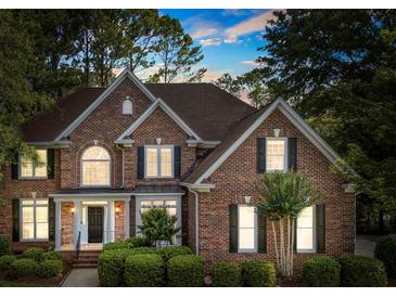 Charming brick two-story home featuring a well-manicured lawn and classic architectural details at 5310 Addington Ct, Charlotte, NC 28277