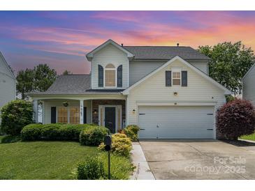 Charming two-story home featuring manicured lawn, stone accents, and attached two car garage at 5723 Lindley Crescent Dr, Indian Trail, NC 28079