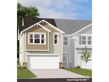 Charming home exterior with a two-car garage, complemented by lovely stonework and neutral paint at 7220 Hodges Meadow Ln, Charlotte, NC 28213