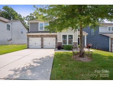 Charming two-story home with a two-car garage, stone accents, and well-maintained landscaping at 10012 Michael Crossing Dr, Charlotte, NC 28213