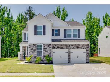 Charming two-story home featuring a stone facade, white siding, and a two-car garage at 1195 Cavalier Ln, Rock Hill, SC 29730