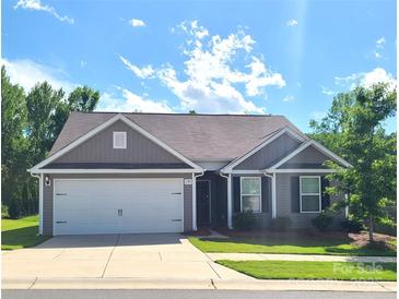 Charming single-story home features a two-car garage and well-maintained lawn at 1195 Winding Creek Rd, Salisbury, NC 28146