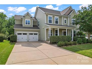 Traditional two-story home with a two-car garage, front porch and well-manicured landscaping at 133 Yellowbell Rd, Mooresville, NC 28117