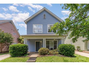Charming two-story home featuring a cozy front porch and well-maintained landscaping at 1825 Stroud Park Ct, Charlotte, NC 28206