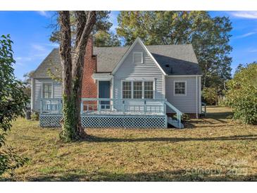 Charming single-story home featuring a cozy front porch, brick chimney, and inviting curb appeal at 4315 Gibbon Rd, Charlotte, NC 28269