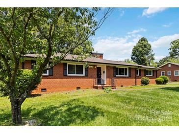 Charming brick home featuring a well-manicured lawn and classic architectural details at 5111 Tewkesbury Rd, Charlotte, NC 28269