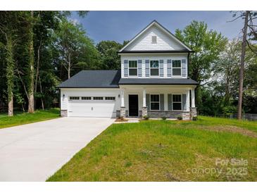 Charming two-story home with a two car garage, stone accents, and a well manicured front lawn at 512 Beverly Cir, Charlotte, NC 28270