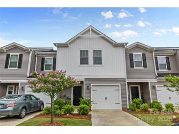 Charming townhome featuring a light gray exterior, an attached garage, and a small tree in the front yard at 524 Tayberry Ln, Fort Mill, SC 29715