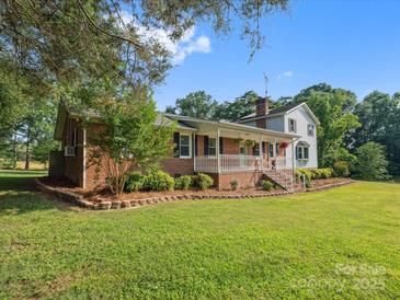 Charming two-story home with a brick and siding exterior, a porch, and a well-maintained lawn at 1238 Carl Allen Rd, Edgemoor, SC 29712