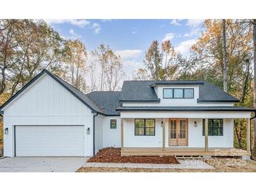 Charming modern farmhouse with a covered porch, attached garage, and clean white siding at 129 John Smith Rd, York, SC 29745
