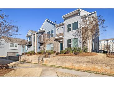 Charming townhome with landscaped front yard and inviting entrance; a great place to call home at 1428 Winding Stream Rd, Charlotte, NC 28206
