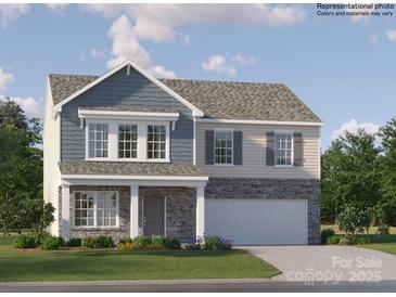 Charming two-story home with stone accents, a covered front porch, and attached two-car garage at 1553 Cottage Creek Dr, Bessemer City, NC 28016