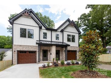Charming two-story home featuring a brick and white facade, a landscaped front yard, and a two-car garage at 1728 Dallas Ave, Charlotte, NC 28205