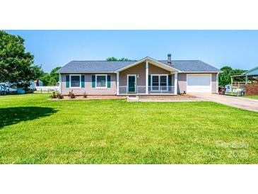 Charming single-story home featuring a well-manicured lawn, cozy front porch, and attached garage at 2031 36Th Ne St, Hickory, NC 28601