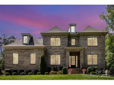 Beautiful brick two-story home with manicured lawn and inviting front entrance at 4005 Capullo Ct, Matthews, NC 28104