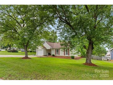 Charming single-story home with a well-manicured lawn and mature trees at 510 Sw Viking Sw Pl, Concord, NC 28025