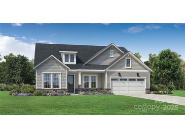 Charming home featuring a well-manicured lawn, inviting entrance, and an attached two-car garage at 5475 Spruce St # 256, Indian Land, SC 29707