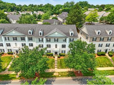 Well-maintained townhouse with charming curb appeal and lush green landscaping at 1134 Plaza Walk Dr, Charlotte, NC 28215