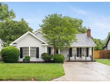 Charming single-story home with a well-manicured lawn, mature landscaping, and a concrete driveway at 12013 Dolomite Dr, Pineville, NC 28134