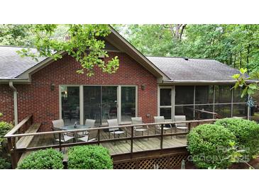 Beautiful brick home featuring an outdoor seating area on a spacious wooden deck at 139 Cricket Creek Dr, Cherryville, NC 28021