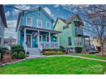 Charming blue two-story home with a welcoming front porch and well-manicured lawn at 228 Coneflower Pl, Fort Mill, SC 29708