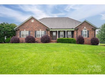 Charming brick home with lush lawn and well-manicured landscaping creates curb appeal at 2817 Long Cir # 1, Iron Station, NC 28080