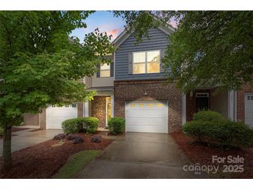 Charming two-story townhome with a brick facade and a one-car garage at 3237 Yarmouth Ln, Gastonia, NC 28056