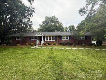 Charming single-story brick home with a well-manicured lawn and mature trees at 3250 Celanese Rd, Rock Hill, SC 29732