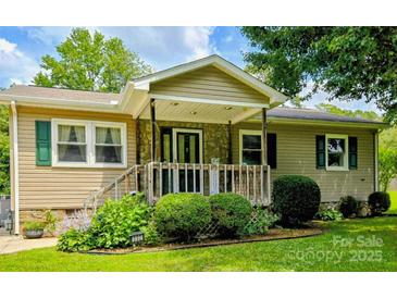 Charming single-story home featuring a stone facade, covered porch, and well-maintained landscaping at 332 Daybrook Dr, Landis, NC 28088