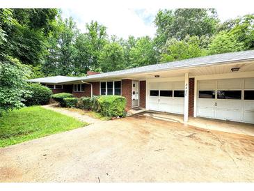 Charming single-story brick home with attached two-car garage and mature landscaping at 3420 Long Ferry Rd, Salisbury, NC 28146