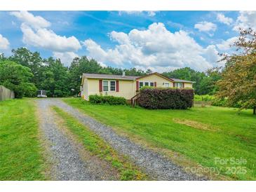 Charming single-story home with a gravel driveway and well-maintained lawn and mature landscaping at 4373 Wentz Rd, Maiden, NC 28650