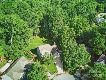 Lush aerial view of a house nestled among mature trees, showcasing its serene setting and green surroundings at 7344 Maitland Ln, Charlotte, NC 28215