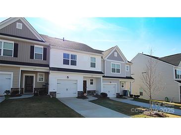 Charming townhome features a well-manicured lawn, one-car garage, and a welcoming exterior at 8177 Sheffield Dr, Terrell, NC 28682