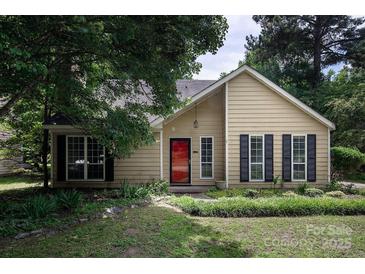 Charming single-Gathering home featuring a red front door, black shutters, and well-maintained landscaping at 8618 Rittenhouse Cir, Charlotte, NC 28270