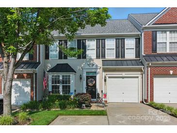 Charming townhome with neutral siding, black shutters, an attached garage, and manicured landscaping at 158 Snead Rd, Fort Mill, SC 29715