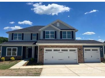 Charming two-story home featuring a stone veneer and a three-car garage at 166 Swann Rd # 5, Statesville, NC 28625