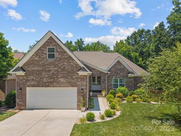 Charming brick home with a two-car garage, well-manicured lawn, and inviting front entrance at 3633 Longpond Ln, Monroe, NC 28110