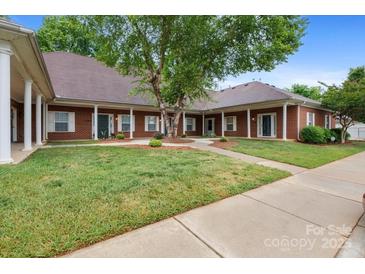 Charming brick exterior with well-manicured lawn and inviting walkways at 7138 Somerset Springs Dr, Charlotte, NC 28262