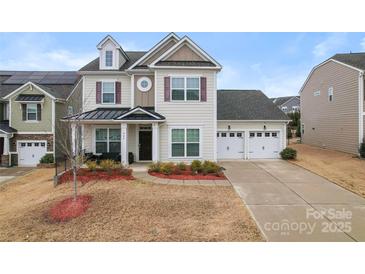 Inviting two-story home featuring a two-car garage and well-manicured landscaping at 966 Nw Parkland Pl, Concord, NC 28027