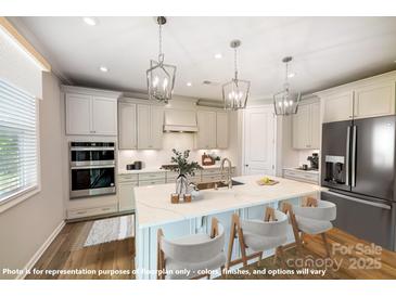Kitchen with white cabinetry, stainless steel appliances, a large island, and pendant lighting at 9864 Quercus Ln, Huntersville, NC 28078